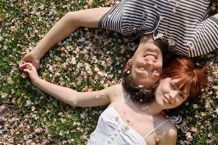romance and spring - Young Couple Lying in the Grass Stock Photo - Premium Royalty-Free, Code: 693-03313114