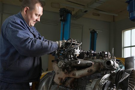 Mechanic Working on Motor Stock Photo - Premium Royalty-Free, Code: 693-03313190