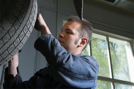 Mechanic Working on Tire Stock Photo - Premium Royalty-Free, Code: 693-03313192