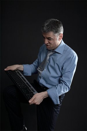 simsearch:693-03314173,k - Worried Businessman with a Computer Keyboard Stock Photo - Premium Royalty-Free, Code: 693-03313285
