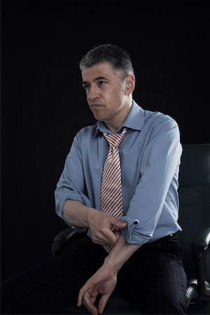 simsearch:693-03314173,k - Businessman Rolling up His Sleeves Stock Photo - Premium Royalty-Free, Code: 693-03313282
