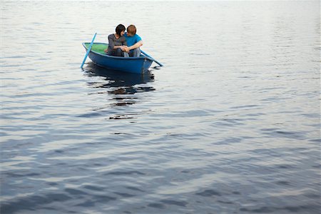 Young Couple Cuddling in Rowboat on Lake Stock Photo - Premium Royalty-Free, Code: 693-03313294