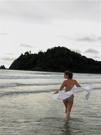 simsearch:693-03313408,k - Young Woman Wading in Ocean Stock Photo - Premium Royalty-Free, Code: 693-03313409
