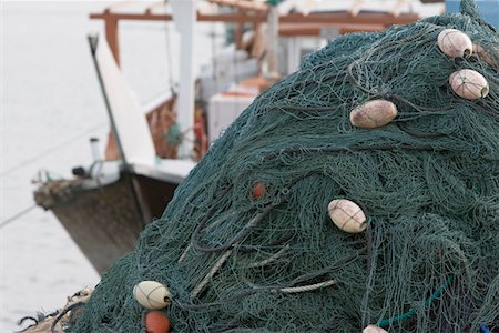 Kalba, UAE, Fishing nets piled high on boat in Kalbar Fujairah Stock Photo - Premium Royalty-Free, Code: 693-03313681