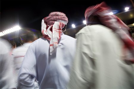 simsearch:693-03313738,k - Dubai, UAE, small group of traditionally dressed Muslim men roaming grounds at Nad Al Sheba Stock Photo - Premium Royalty-Free, Code: 693-03313738