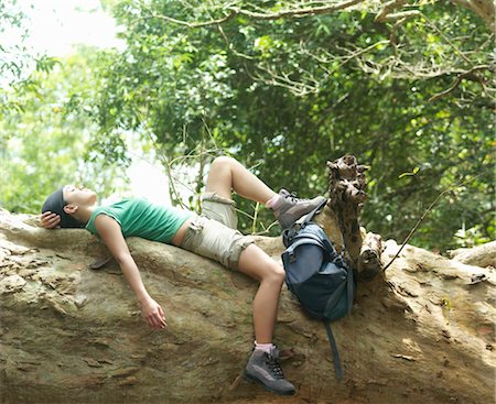 simsearch:693-03307574,k - Young woman resting on rock formation in forest, side view Stock Photo - Premium Royalty-Free, Code: 693-03363706