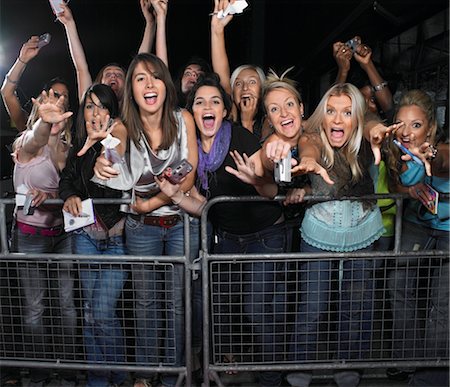 exhilarating - Fans leaning over barrier and screaming Stock Photo - Premium Royalty-Free, Code: 693-03440752