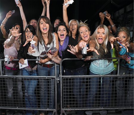 Fans leaning over barrier and screaming Stock Photo - Premium Royalty-Free, Code: 693-03440752