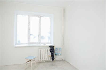 empty house - Old clothes on radiator under window of new apartment Stock Photo - Premium Royalty-Free, Code: 693-03440792
