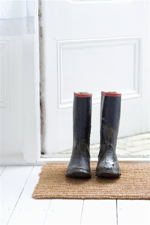 shoes by door - Muddy boots on door mat Stock Photo - Premium Royalty-Free, Code: 693-03440864