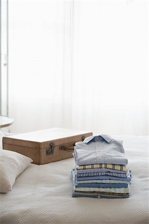 shirt nobody - Ironed and folded shirts next to a suitcase Stock Photo - Premium Royalty-Free, Code: 693-03440877