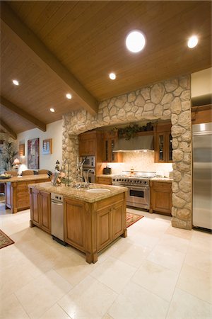 simsearch:693-03474115,k - Exposed stone kitchen surround with spotlights on wooden ceiling Foto de stock - Sin royalties Premium, Código: 693-03474090