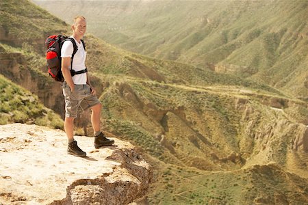 Hiker standing on top of mountain Stock Photo - Premium Royalty-Free, Code: 693-03557111