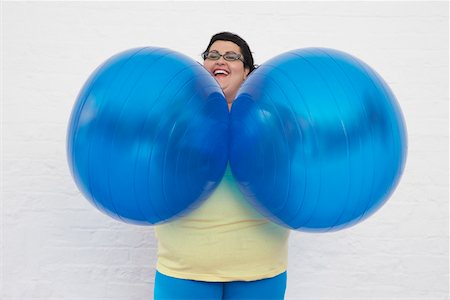 funny pictures with exercise balls - Happy Overweight Woman Holding Exercise Balls Stock Photo - Premium Royalty-Free, Code: 693-03557453