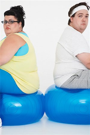 simsearch:693-03557462,k - Unhappy overweight man and woman sitting back to back on exercise balls, portrait Stock Photo - Premium Royalty-Free, Code: 693-03557462