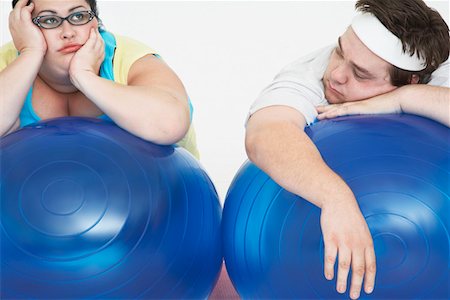 fat women exercise on ball - Disinterested overweight man and woman lying on Exercise Balls, close up Foto de stock - Sin royalties Premium, Código: 693-03557463