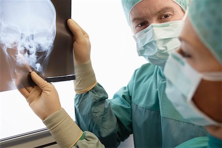 photograph woman and skeleton - Radiologists Examining X-Ray of skull Stock Photo - Premium Royalty-Free, Code: 693-03557535