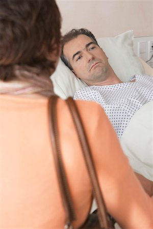 Woman Visiting Husband in Hospital, over the shoulder Stock Photo - Premium Royalty-Free, Code: 693-03557530