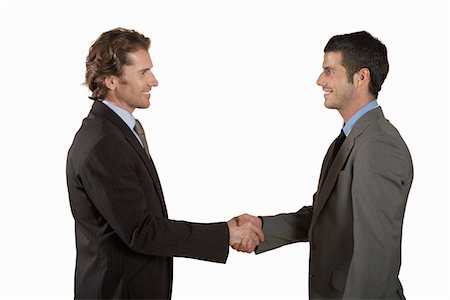 Businessmen shaking hands, on white background Stock Photo - Premium Royalty-Free, Code: 693-03564546