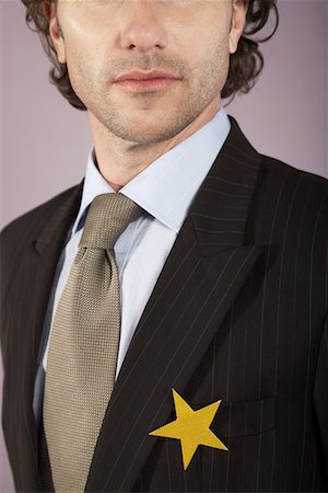 Businessman with gold star on suit, portrait Foto de stock - Sin royalties Premium, Código: 693-03564542