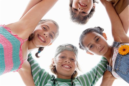 Children arms interlocked, Huddling in a Circle, view from below Stock Photo - Premium Royalty-Free, Code: 693-03564599