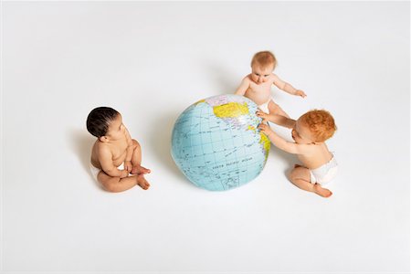 Babies Playing With Globe Stock Photo - Premium Royalty-Free, Code: 693-03565128