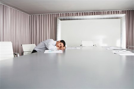 sleeping on boardroom table - Businessman Sleeping in Conference Room Stock Photo - Premium Royalty-Free, Code: 693-03565212