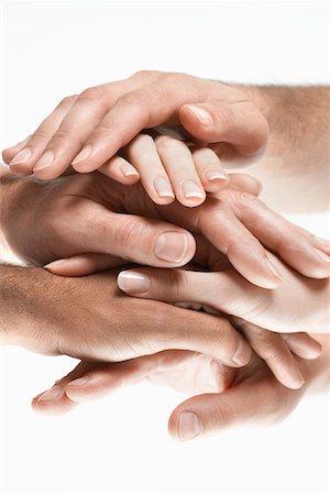 Young men and women stacking hands, close up of hands Stock Photo - Premium Royalty-Free, Code: 693-03565254