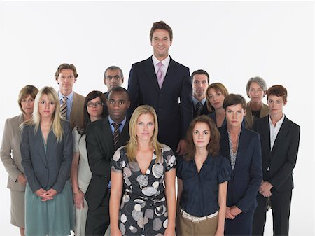 Group of businesspeople, man standing taller Stock Photo - Premium Royalty-Free, Code: 693-03565278