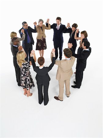 Group of Businesspeople in a circle, holding hands Stock Photo - Premium Royalty-Free, Code: 693-03565279