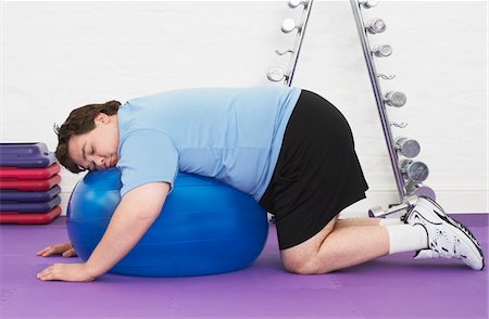 fat man on exercise ball - Overweight Man sleeping on Exercise Ball in health club Stock Photo - Premium Royalty-Free, Code: 693-03565328