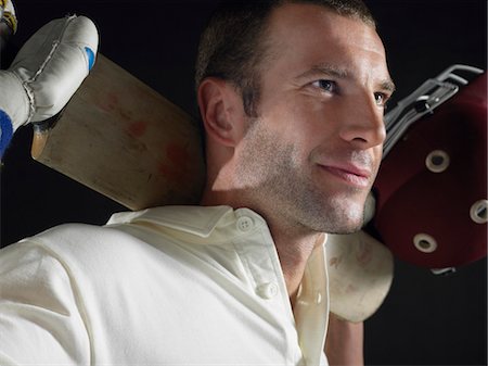 simsearch:693-03565397,k - Cricket player holding cricket bat behind shoulders, close-up Stock Photo - Premium Royalty-Free, Code: 693-03565400