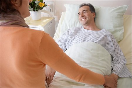 Visitor Comforting Patient in Hospital Stock Photo - Premium Royalty-Free, Code: 693-03565444