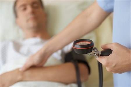 sinais vitais - Nurse Taking Blood Pressure of Patient Foto de stock - Royalty Free Premium, Número: 693-03565443