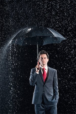 simsearch:693-03303406,k - Businessman standing under sturdy Umbrella, hand in pocket Foto de stock - Sin royalties Premium, Código: 693-03565492