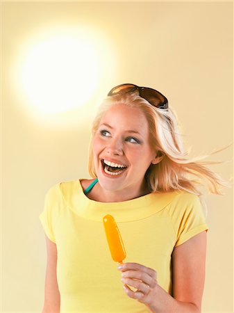 Smiling woman holding popsicle on hot Summer Day Stock Photo - Premium Royalty-Free, Code: 693-03565509