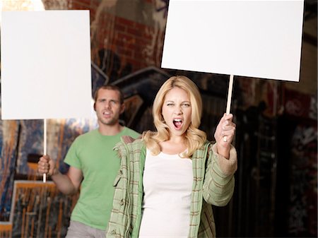 riot - Young man and woman holding blank demonstration placards Stock Photo - Premium Royalty-Free, Code: 693-03565613