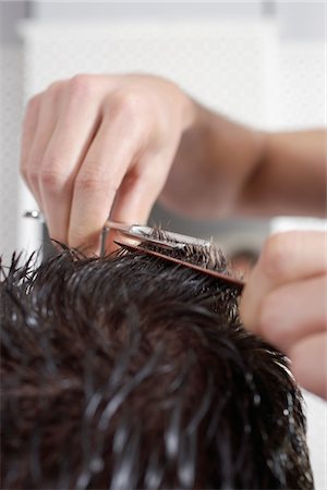 Barber cutting mans hair in barber shop, close-up Stock Photo - Premium Royalty-Free, Code: 693-03565758