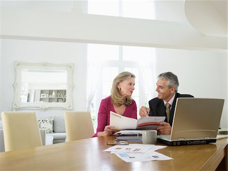 dialog at home man woman - Woman sitting at table with financial advisor Stock Photo - Premium Royalty-Free, Code: 693-03565764