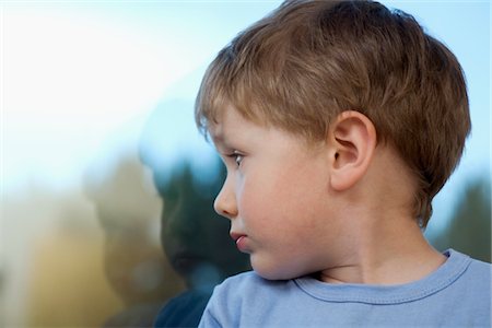 sad alone profile - Young boy looking back at shadow in glass Stock Photo - Premium Royalty-Free, Code: 693-03617138