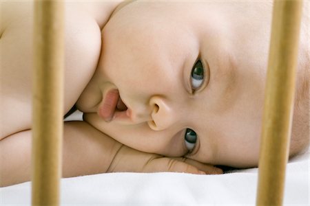 Infant child lying in cot Foto de stock - Sin royalties Premium, Código: 693-03617152