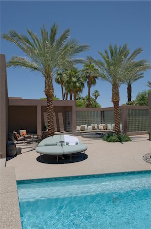 seating at the pool - Seating with palm trees on poolside of Californian home Stock Photo - Premium Royalty-Free, Code: 693-03643931