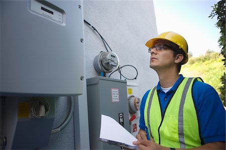 reading (from a meter or gauge) - Maintenance worker reads meter of solar generation unit in Los Angeles, California Stock Photo - Premium Royalty-Free, Code: 693-03643974