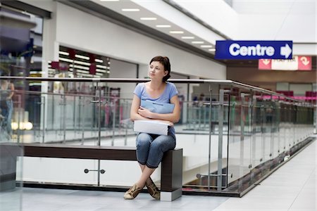 Young woman sits in new Voronezh shopping centre Stock Photo - Premium Royalty-Free, Code: 693-03643995