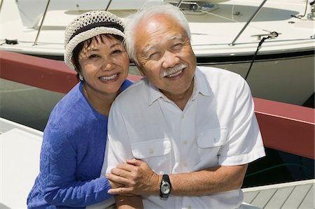 senior couple sitting on dock - Senior couple embracing in Marina, (portrait) Stock Photo - Premium Royalty-Free, Code: 693-03686286