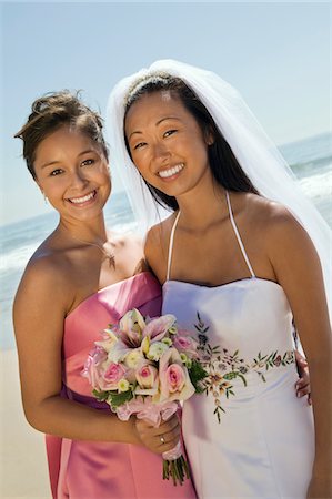 simsearch:693-03686309,k - Bride and Bridesmaid smiling on beach, (portrait) Stock Photo - Premium Royalty-Free, Code: 693-03686314