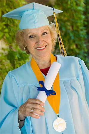 Senior graduate holding diploma outside, portrait Stock Photo - Premium Royalty-Free, Code: 693-03686372