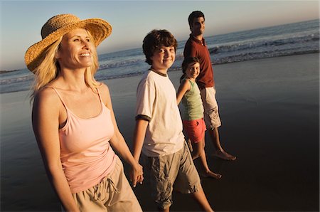 simsearch:693-03314791,k - Family walking on beach at dusk Stock Photo - Premium Royalty-Free, Code: 693-03686437