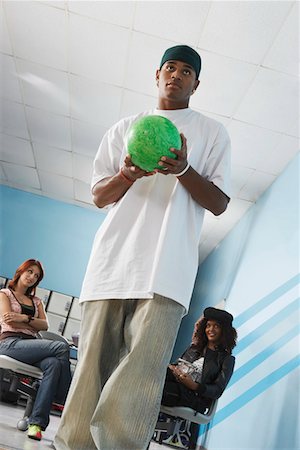 simsearch:693-06015216,k - Young man at bowling alley holding ball, portrait, low angle view Stock Photo - Premium Royalty-Free, Code: 693-03686473