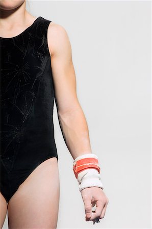 Gymnast (13-15) in leotard wearing palm guards, mid section Stock Photo - Premium Royalty-Free, Code: 693-03686481